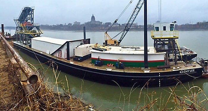 The sand dredge Kathy Lee sits moored to the north bank of the Missouri River.